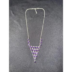 This is a sterling silver amethyst bib necklace with oval cabochon stones. 20”